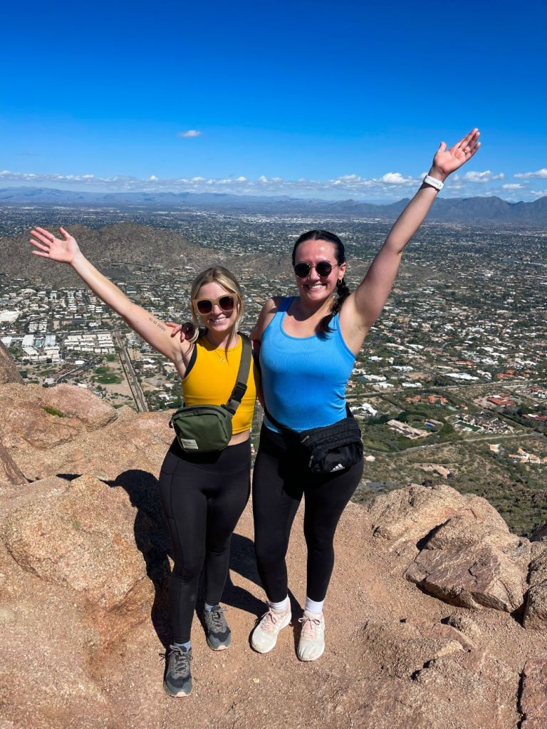 Two women at the top of Camelback Mountain in Scottsdale, Arizona
