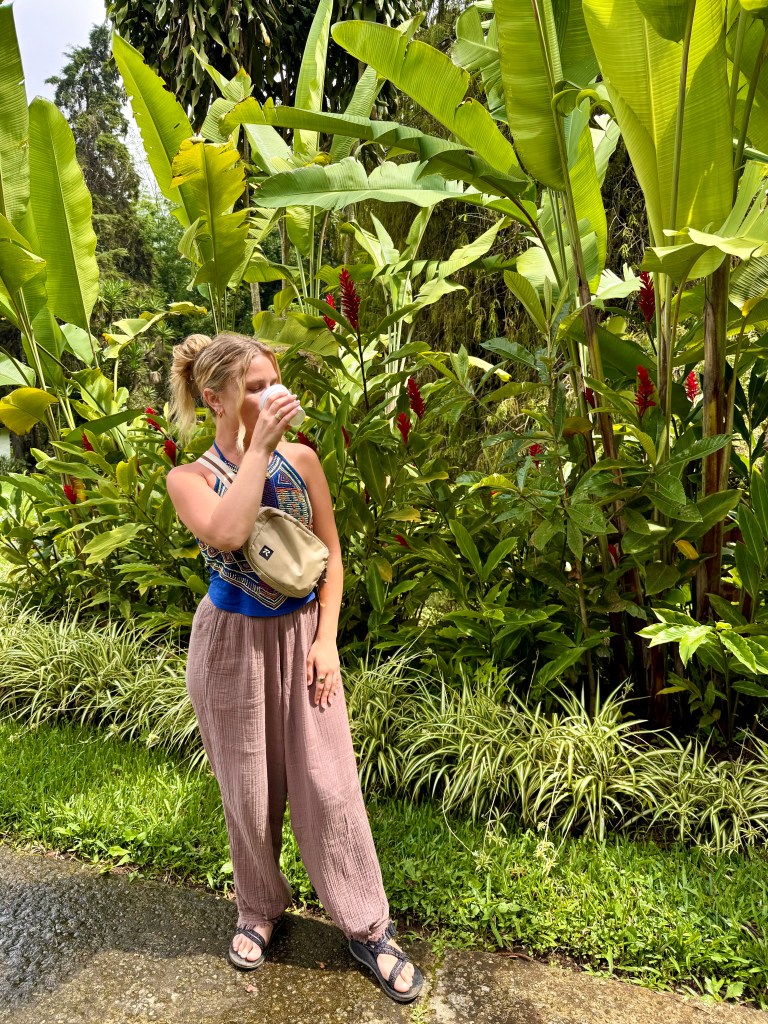 Woman drinking a cup of coffee at El Carmen Estate in El Salvador